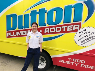 a girl in Dutton Plumbing truck