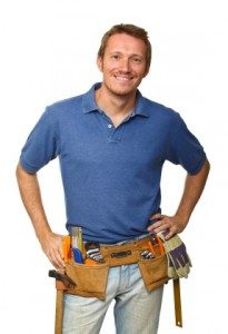 A medium shot shows a smiling man, likely a contractor, wearing a toolbelt and casual clothing.