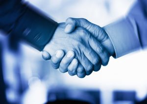 A close up shot of a handshake between two people.