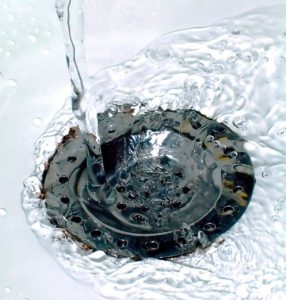 Water drains down a kitchen sink drain